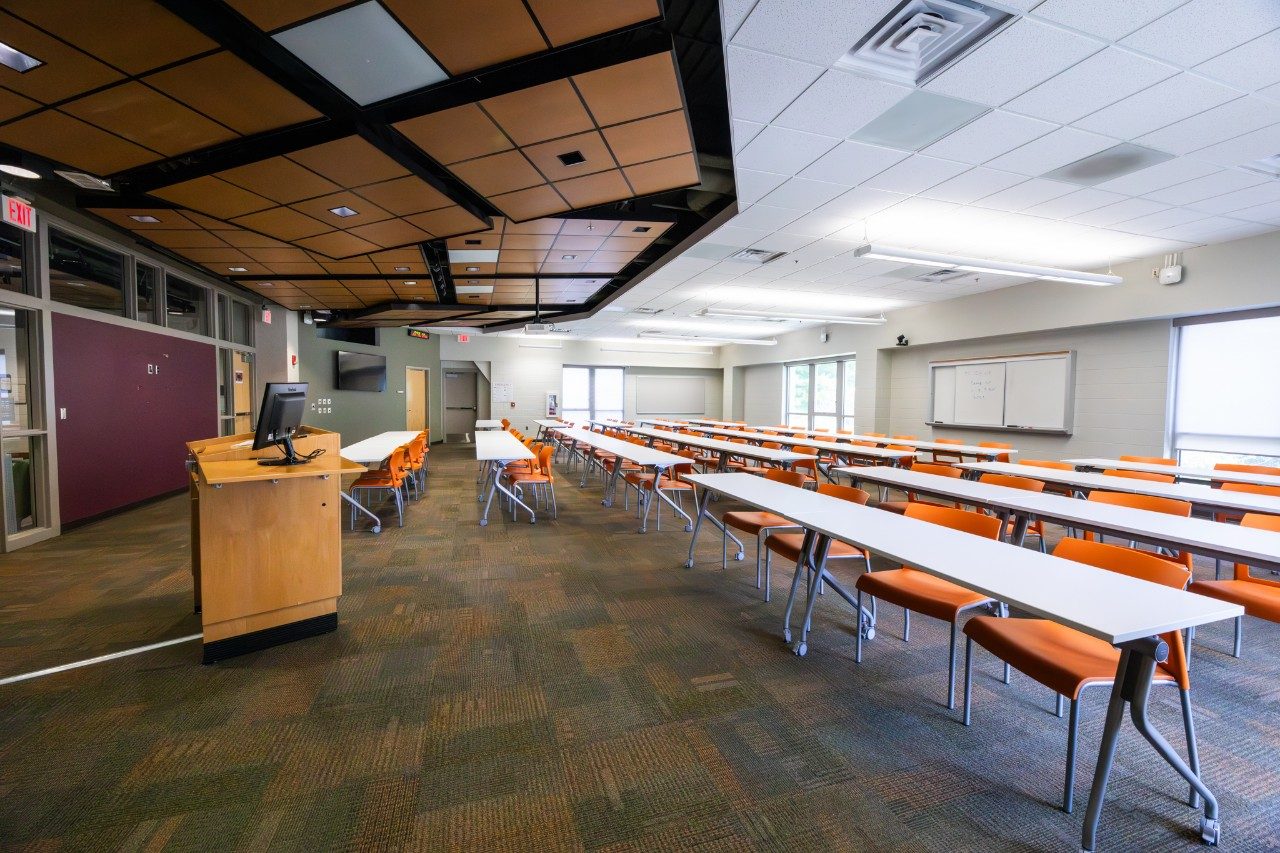 A classroom with orange chairs inside Bishop-Favrao.