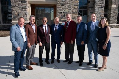  Preston White, Virginia Tech President Tim Sands, Myers-Lawson School of Construction Preston and Catharine White Professor and Director Brian Kleiner, A. Ross Myers, John R. Lawson, Brett Hitt, George B. Clarke IV, and Paul and Dorothea Torgersen Dean of Engineering Julie Ross stand in front of Hitt Hall. 