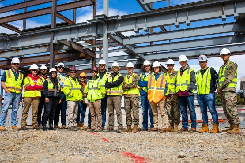 Group of students at construction site in safety gear