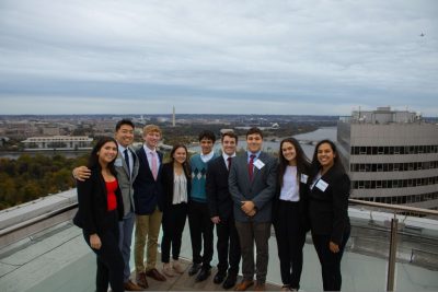 Students in a real estate program pose for a photo with D.C. in the background.