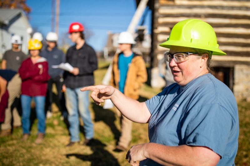 A professor instructs her class at a work site.