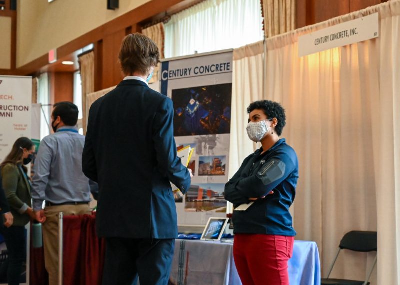 Student talking to person at career fair 2021