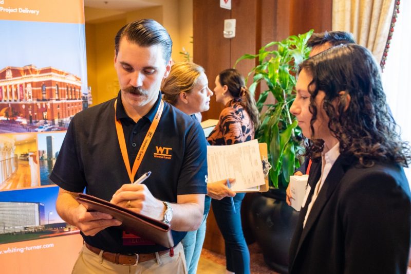 A student talks with a recruiter during a career fair.