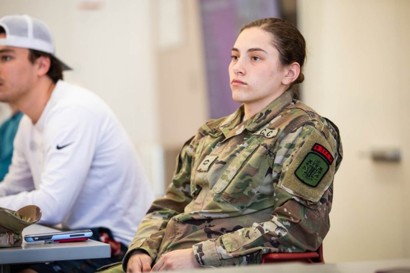 A student wearing a uniform sits in class.
