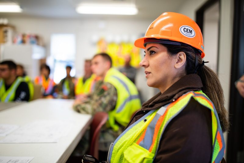 A student wearing a hardhat observes a lesson during class.